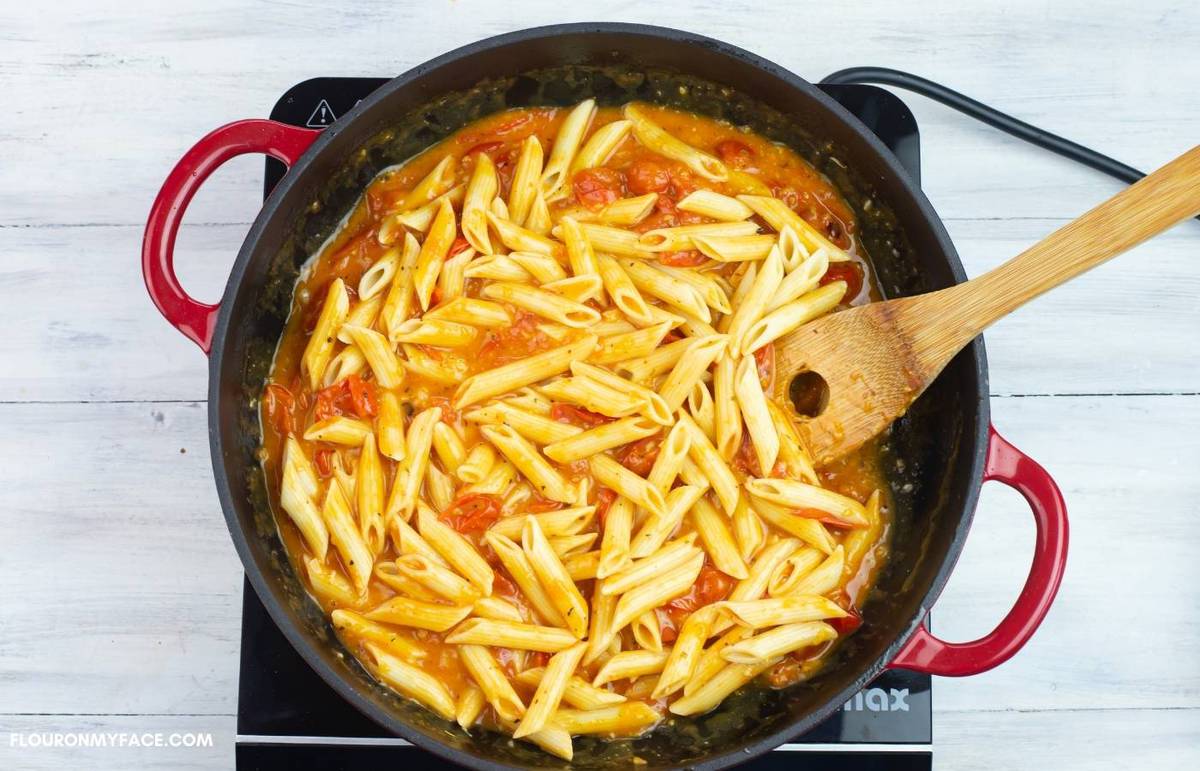 Penne pasta with tomato sauce in a skillet.