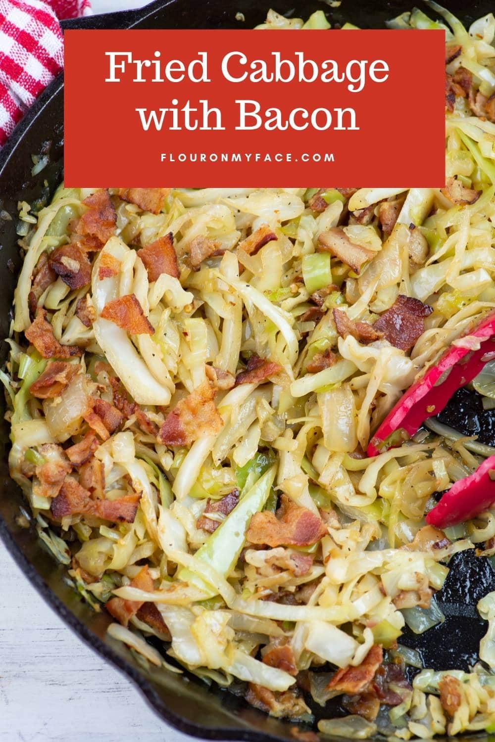 Cabbage cooked with bacon in a cast iron skillet.