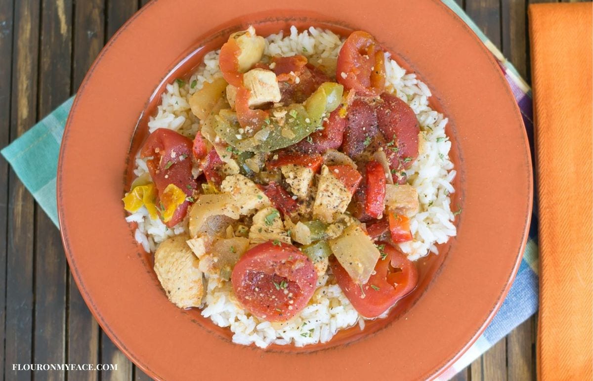 A bowl filled with chicken gumbo soup served over rice.