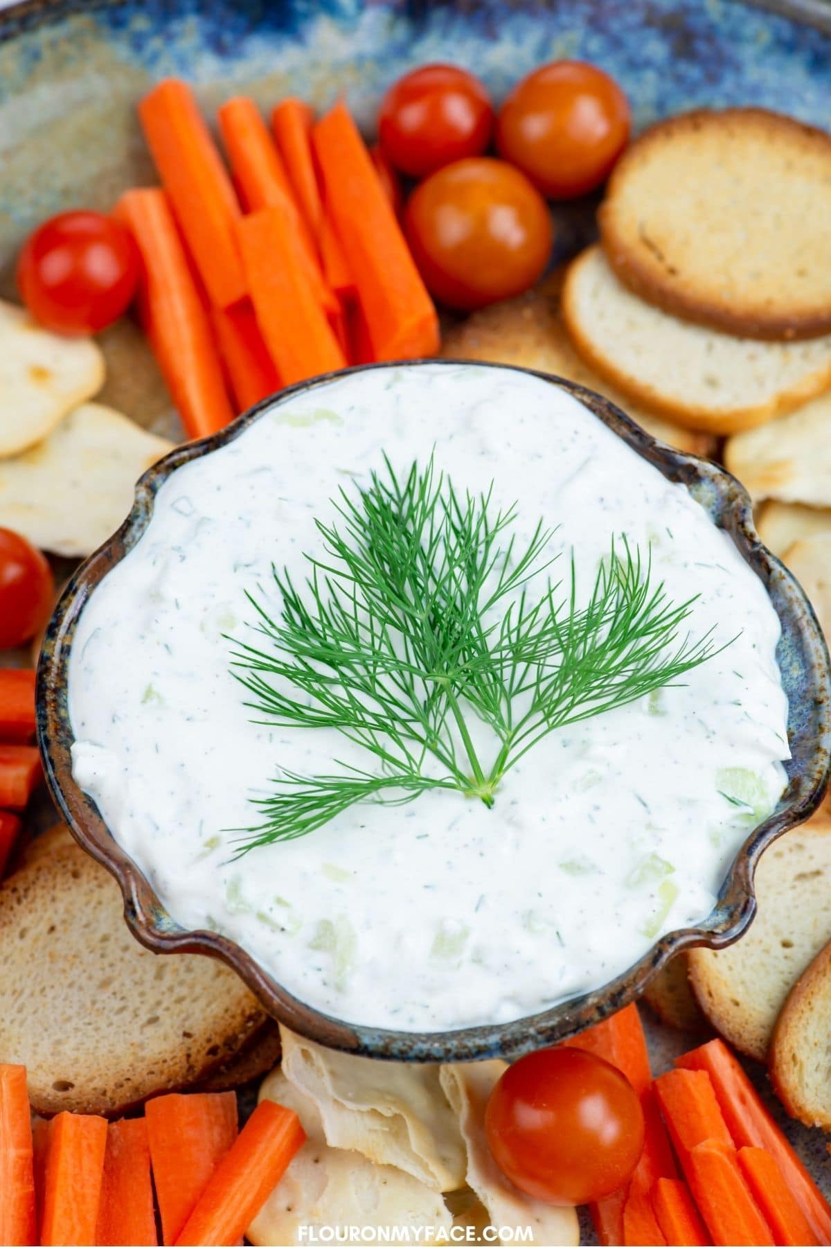 Dip dip garnished with dill leaves.