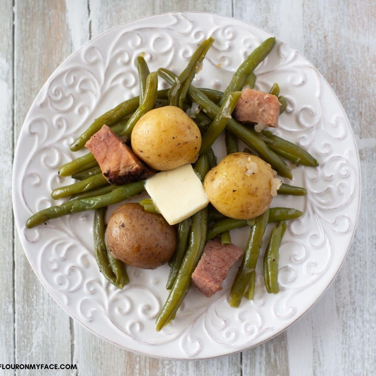 Green beans and baby potatoes on a plate.