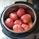 Uncooked red potatoes inside an Instant Pot before pressure cooking.