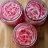 Overhead image of quick pickled red onions in jars.