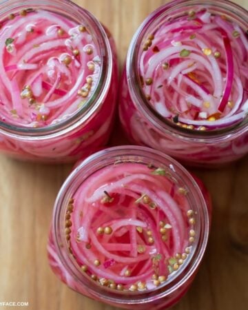 Overhead image of quick pickled red onions in jars.