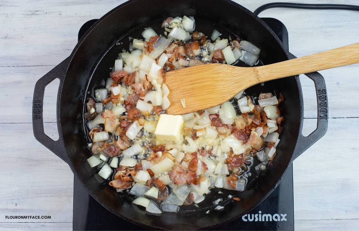 Adding butter to bacon, onion and garlic.