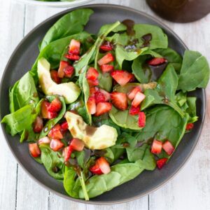 balsamic salad dressing drizzled on a spinach salad.