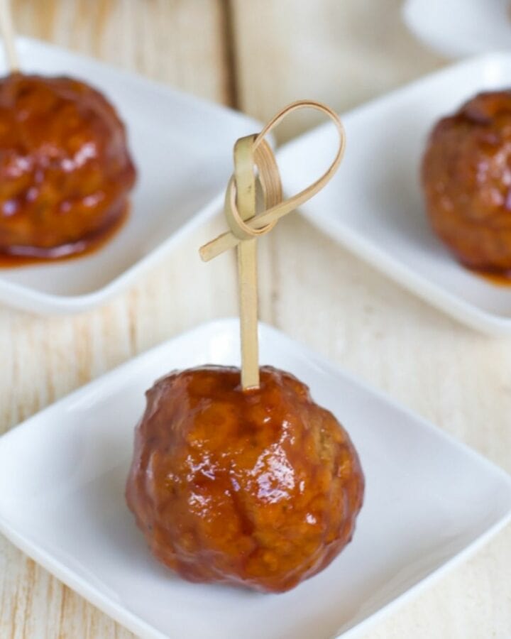 Spicy cherry meatball appetizers on serving cups.