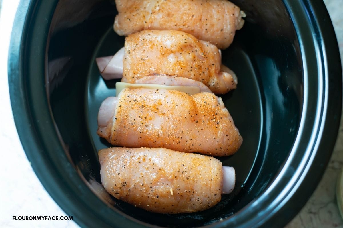 Chicken Cordon Bleu rolls in a crock pot.