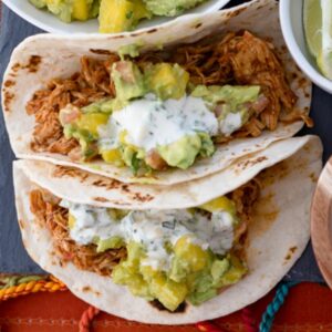 Creamy Jalapeno Sauce drizzled on chicken tacos.