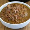 Shredded beef in a white bowl.