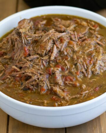 Shredded beef in a white bowl.