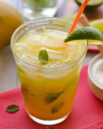 Mango Mojito in a tall glass with a straw.