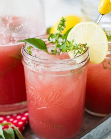Mason jars filled with Watermelon Thyme Lemonade.