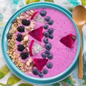 Overhead image looking down into a bowl filled with a dragon fruit smoothie bowl.