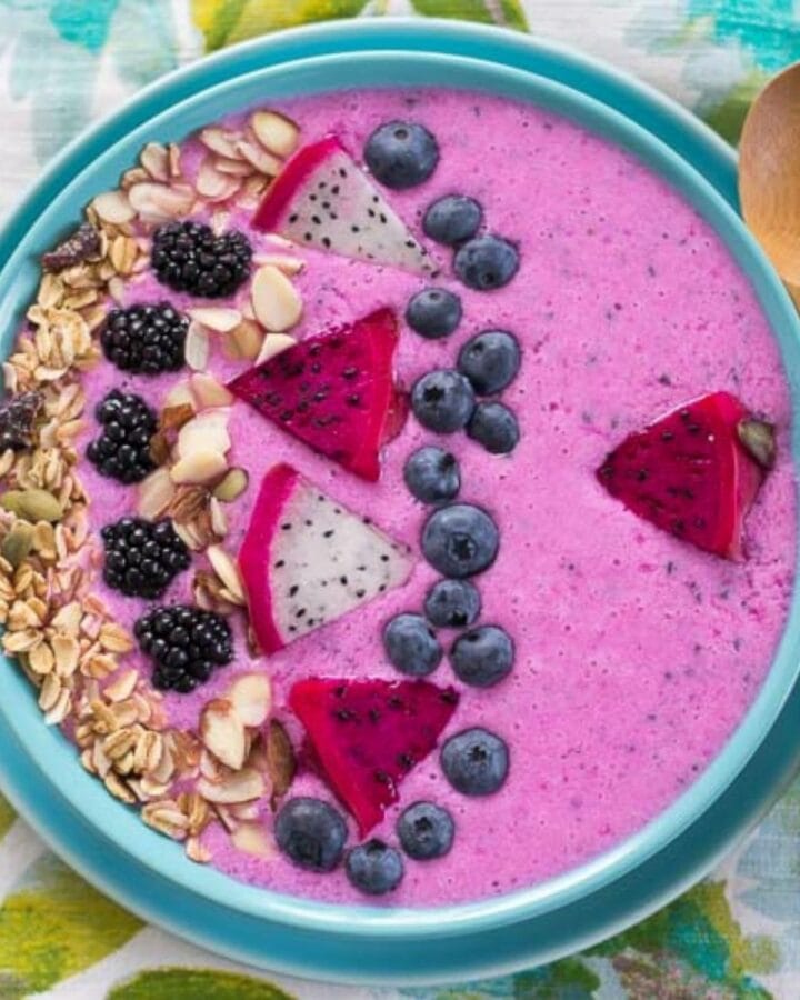 Overhead image looking down into a bowl filled with a dragon fruit smoothie bowl.