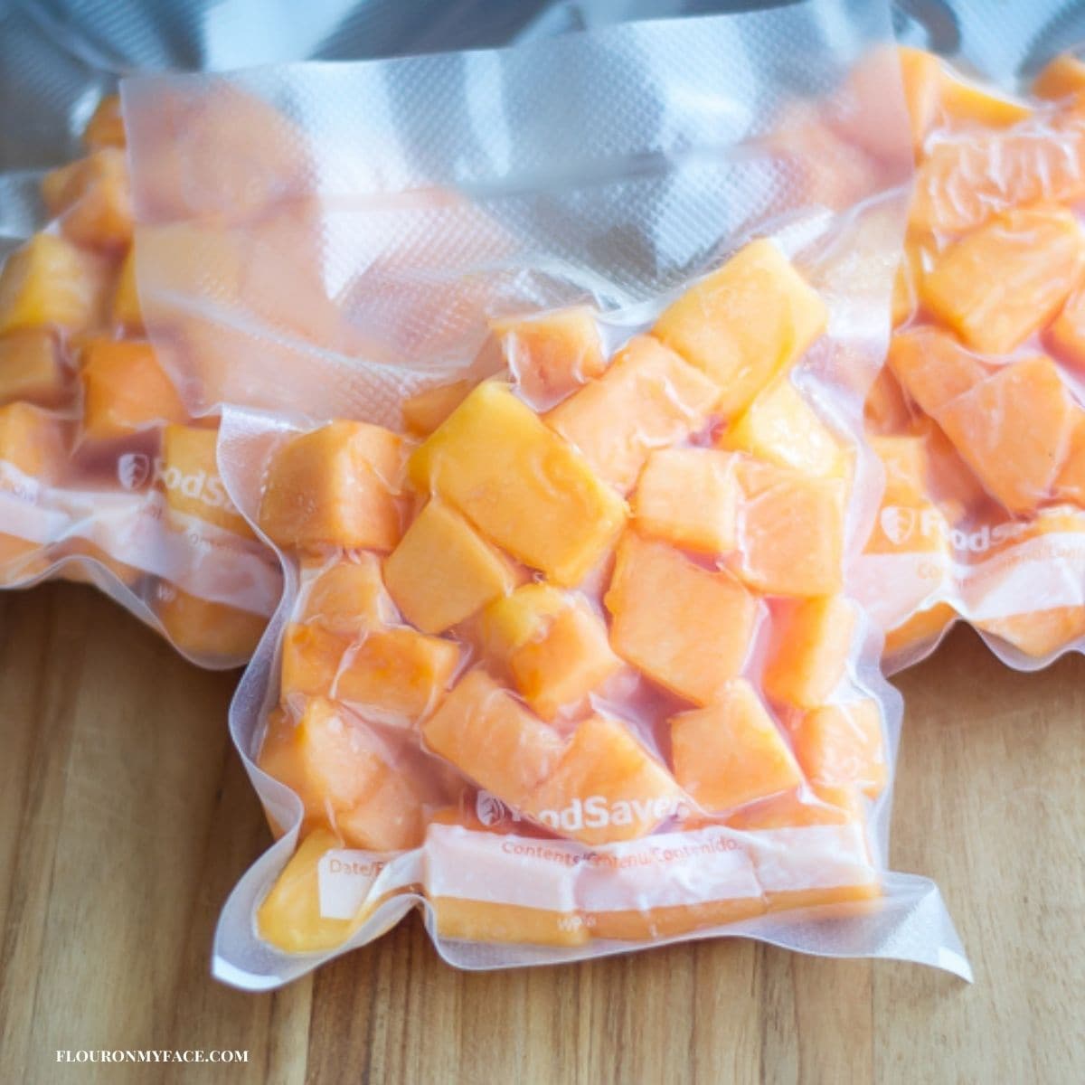 Cubed papaya in freezer bags.
