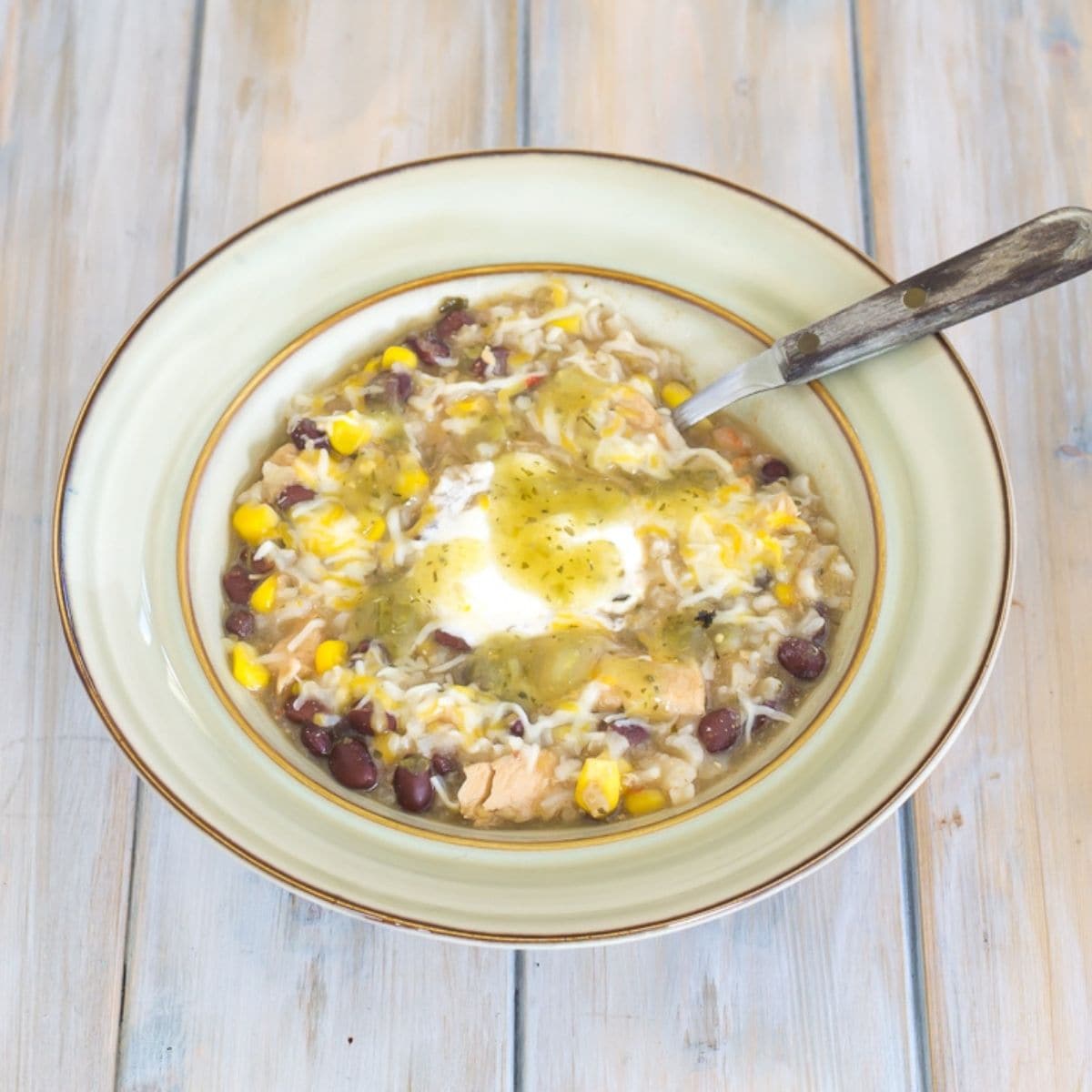 A soup bowl filled with garlic lime chicken salsa soup.