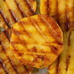 Close up of sliced pineapple that has been seasoned with chili lime andand grilled.