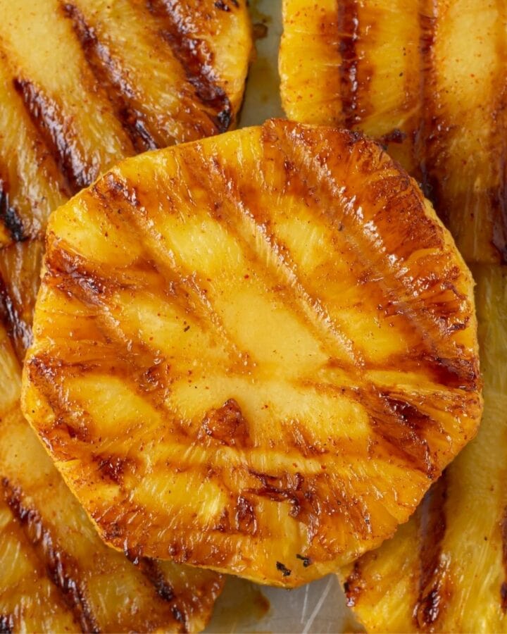 Close up of sliced pineapple that has been seasoned with chili lime andand grilled.