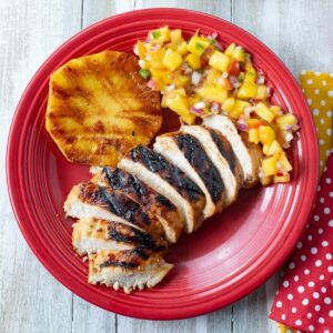 Key lime grilled chicken with sides on a plate.