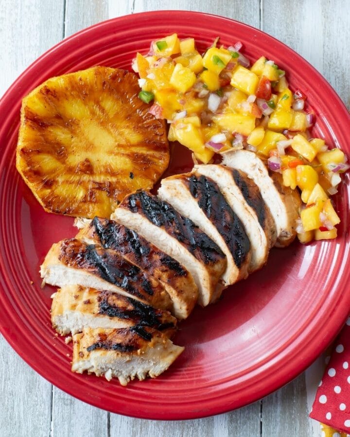 Key lime grilled chicken with sides on a plate.