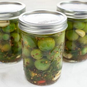 Pickled Green Cherry Tomatoes in mason jars.
