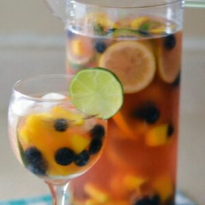 Pink Moscato Sangria in a tall pitcher with a filled glass.