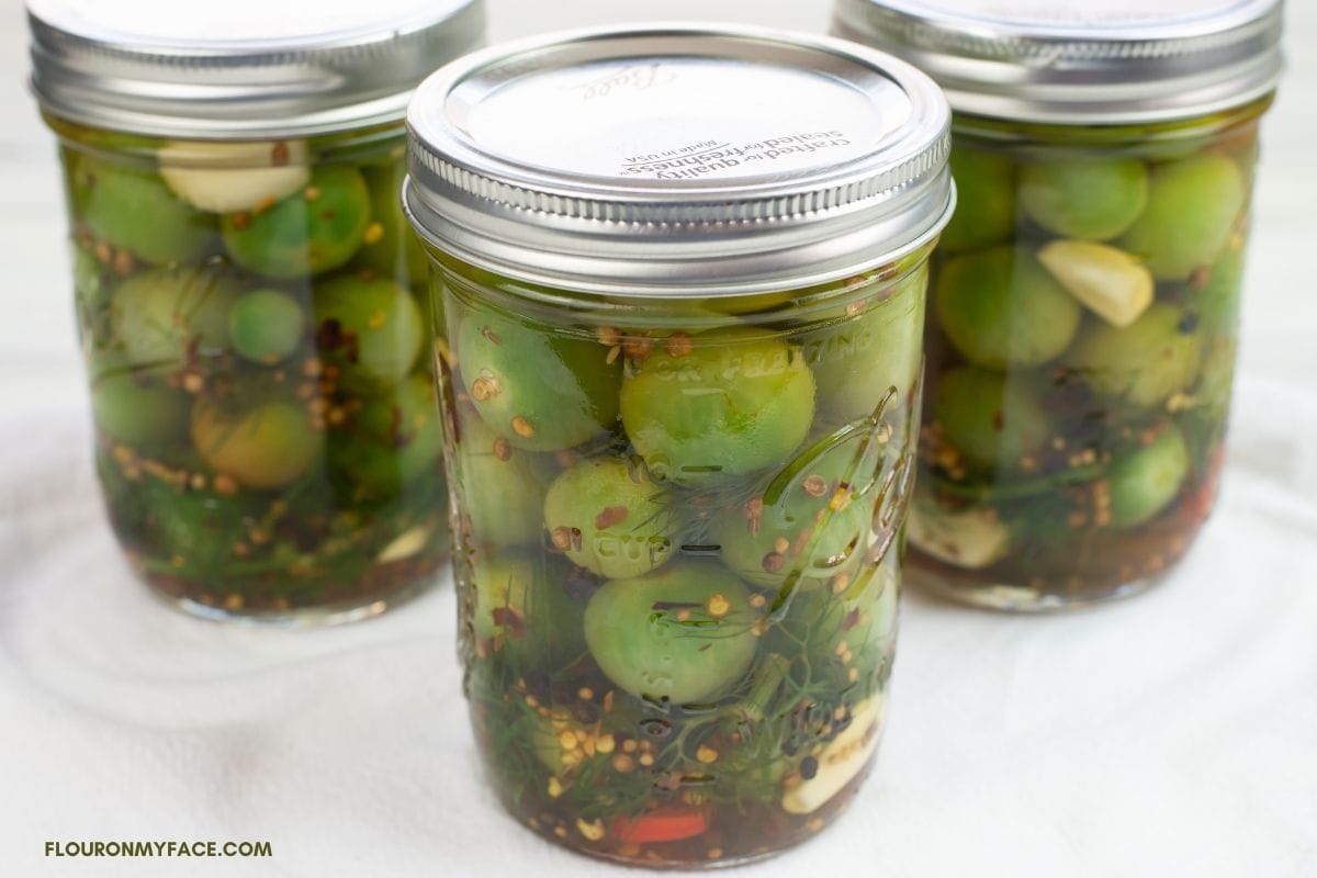 Pickled Green cherry tomatoes in jars.