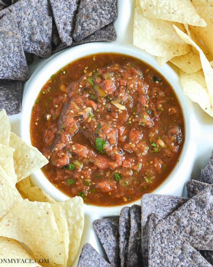 Roasted Tomatillo Salsa in a dip bowl with chips.
