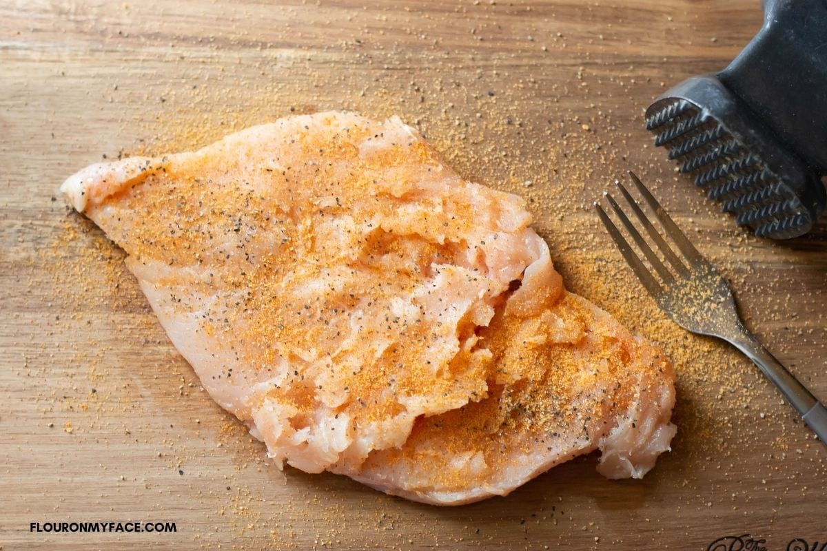 A flattened and seasoned chicken breast.