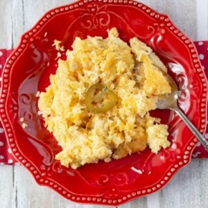 Southern style spoon bread on a red plate.