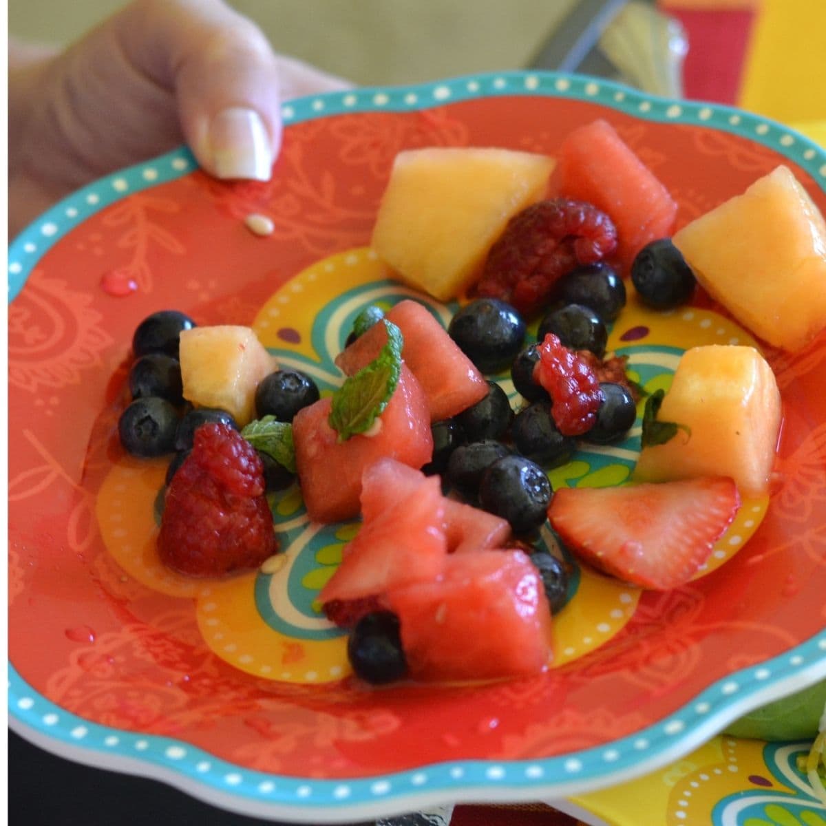 A plate with a serving of summer fruit salad.