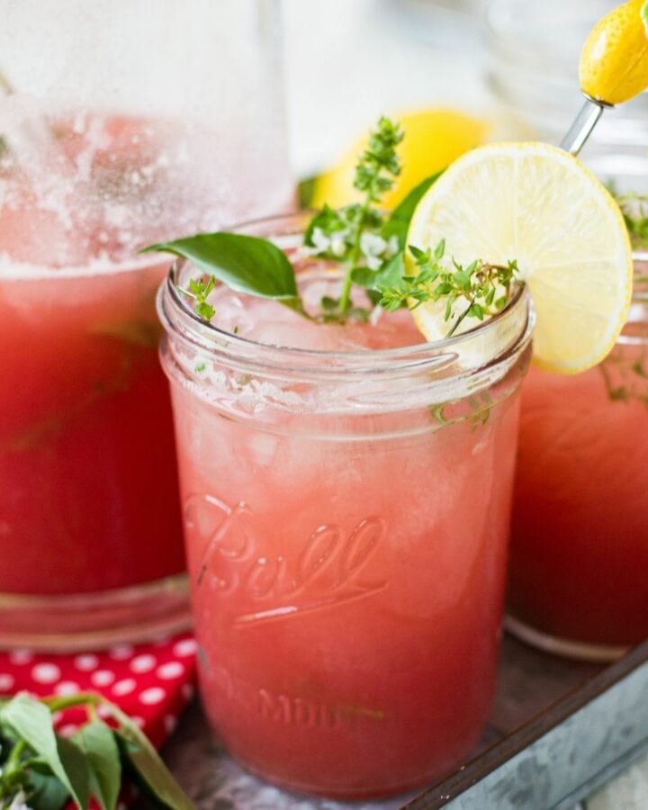 Mason jars filled with Watermelon Thyme Lemonade.