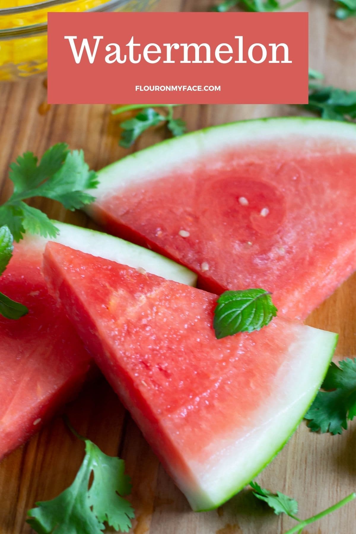 Watermelon wedges on a cutting board.