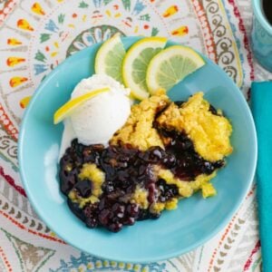 Blueberry Lemon Dump Cake with a scoop of vanilla ice cream in a bowl.