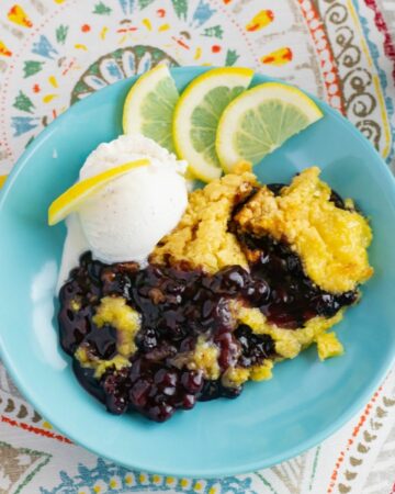 Blueberry Lemon Dump Cake with a scoop of vanilla ice cream in a bowl.