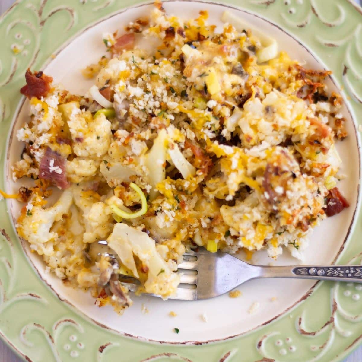 A dinner plate with a serving of cauliflower. leek and mushroom casserole.