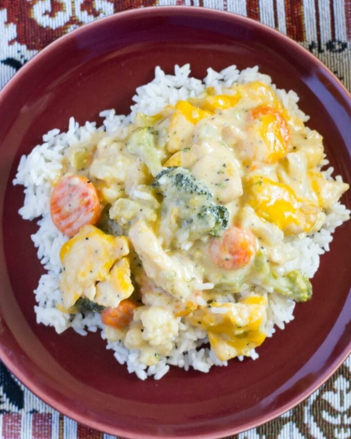 Creamy Chicken and Vegetables served over rice on a dinner plate..