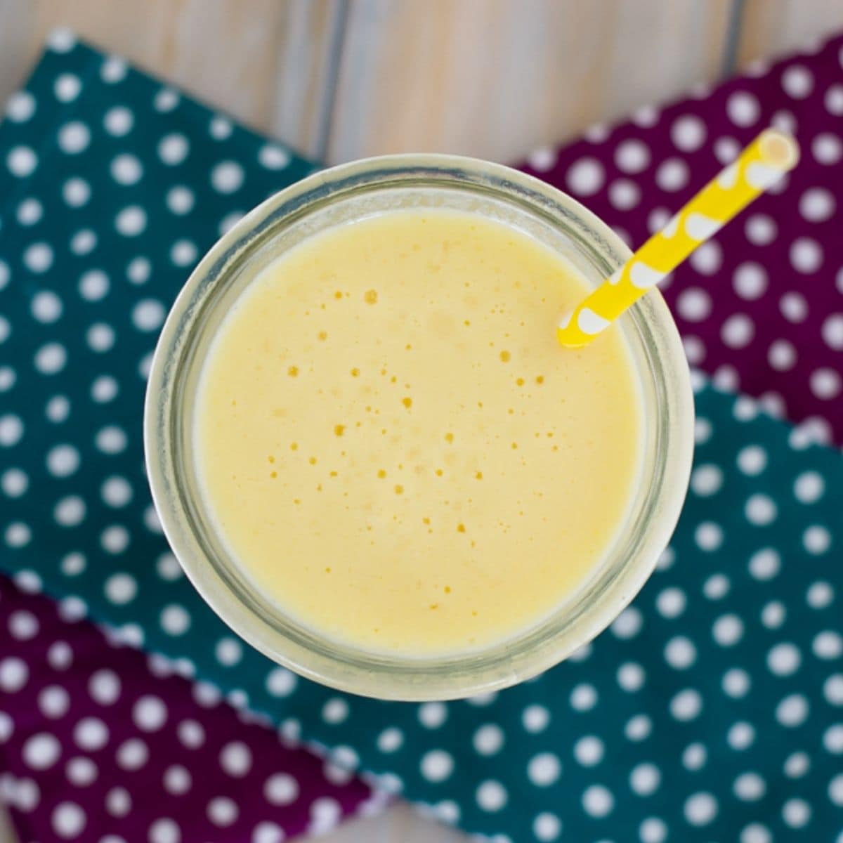 Overhead image of a glass filled with Pineapple Mango Smoothie.