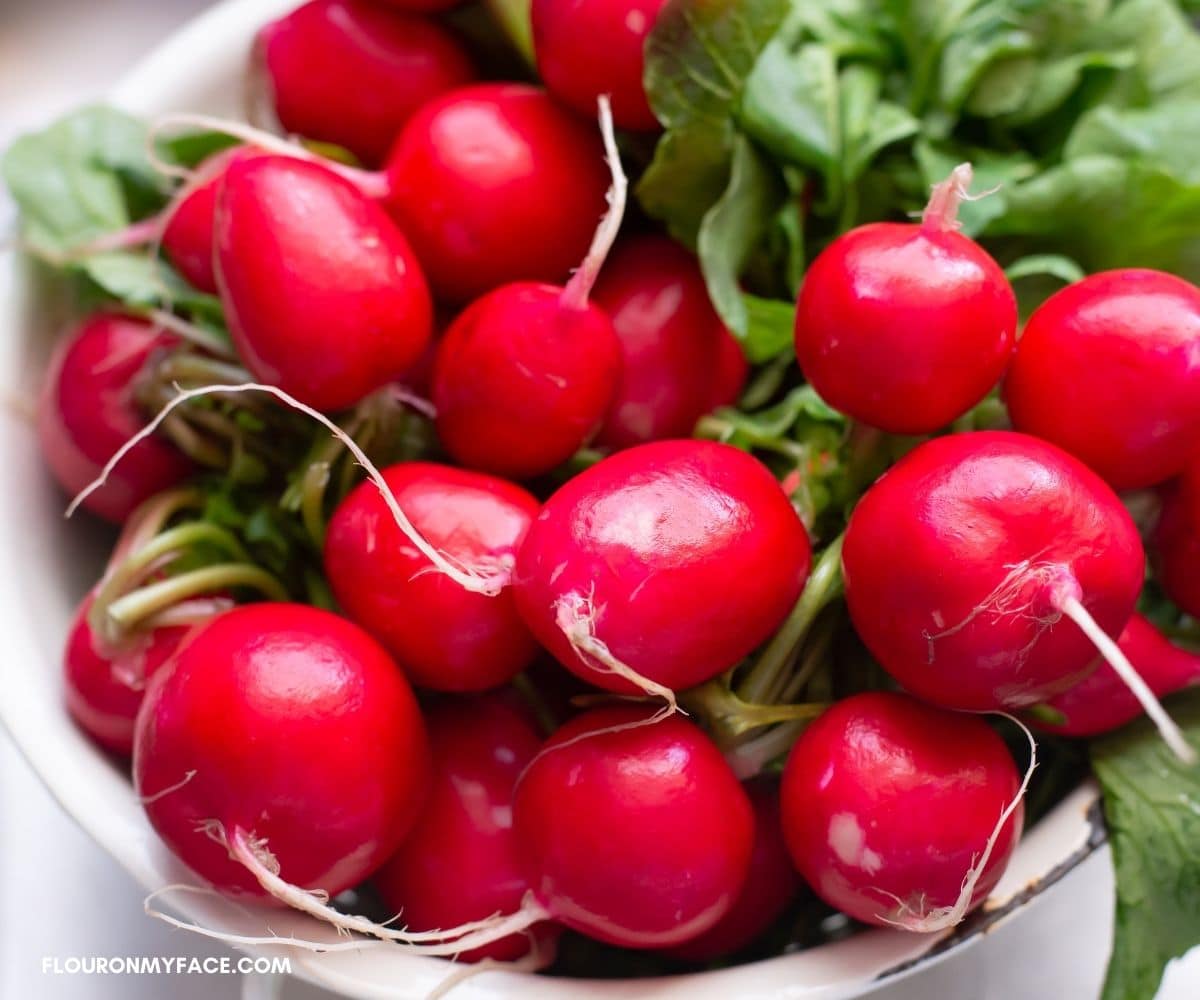 Fresh radishes in a colander.