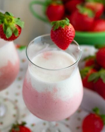 Layered strawberry and cream smoothie.