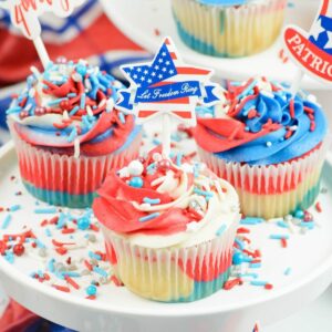 Red white and blue 4th of July Cupcakes on a cake stand.