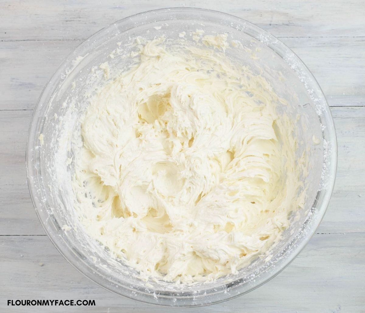 A bowl filled with fluffy buttercream frosting.