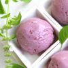 Scoops of Blackberry Lemon Basil Gelato in small white square bowls.