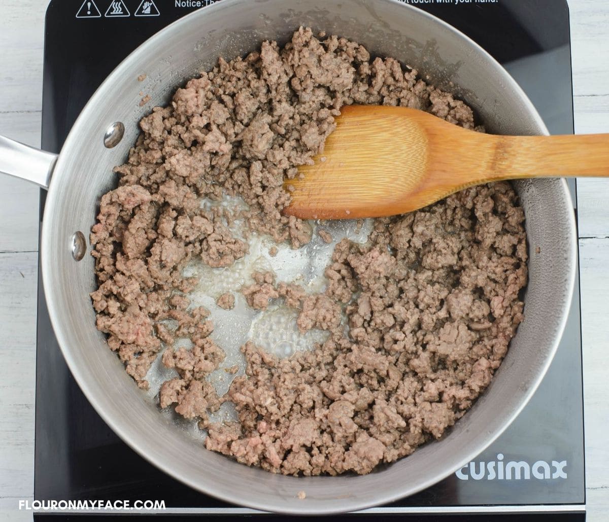 Browning ground beef for homemade pasta sauce in a skillet.