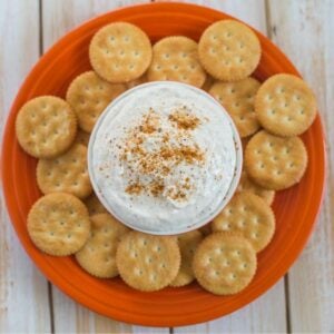 Crab dip in a small bowl with crackers.