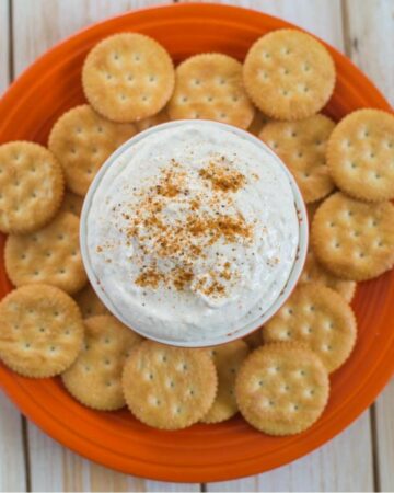 Crab dip in a small bowl with crackers.