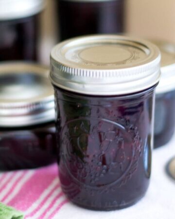 Canning jars filled with homemade strawberry blueberry jam.