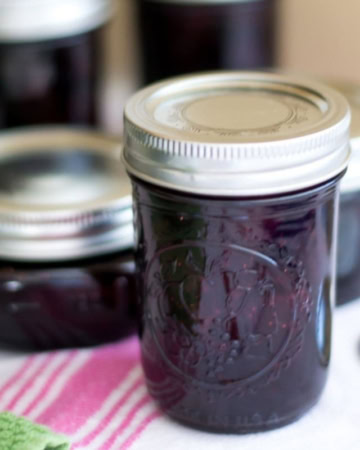 Canning jars filled with homemade strawberry blueberry jam.