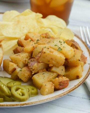 Closeup of a serving of garlic potatoes on a dinner plate.